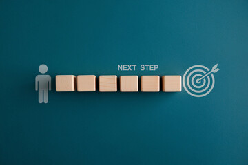 Wooden blocks symbolizing steps towards a goal, represented by a target, showcasing a progression concept ideal for business or planning visuals