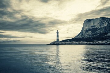 A scenic view of a lighthouse near a cliff under a cloudy sky reflecting on the ocean surface water area