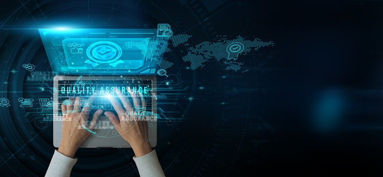 Man using a laptop with Quality Assurance on the keyboard analyzing and developing various information about process monitoring defect detection testing standards compliance, continuous improvement.