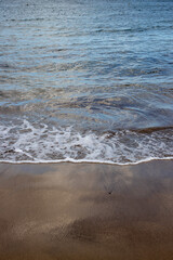 Sand beach and a line of the tide, Gran Canaria, Spain