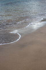 Sand beach and a line of the tide, Gran Canaria, Spain