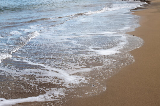 Sand beach and a line of the tide, Gran Canaria, Spain