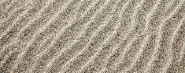 Sand texture closeup with natural ripple pattern on surface. Ideal for nature, travel, eco-friendly and minimalist design projects