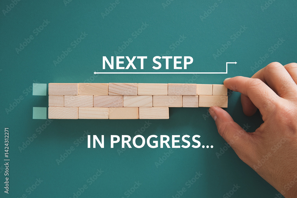 Poster hand placing wooden block, symbolizing next step in progress, on teal background with 