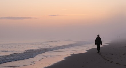 Person Walking Along the Beach at Sunrise