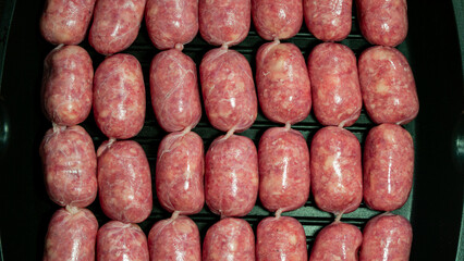 Raw Sausages Background on a Frying Pan. Process of Preparing Tasty Hotdogs. Unhealthy Food. Meat for Grill Barbeque