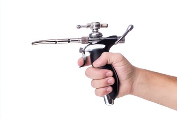 Naklejka premium Hand holding airbrush tool for professional painting on a clean white background