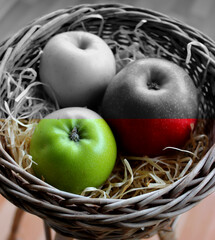 Handmade Basket Filled with Wood Shavings and Whole Apples Variety Types on It Split in Color Stock Image. Healthy and Unhealthy Fruits Concept Photo
