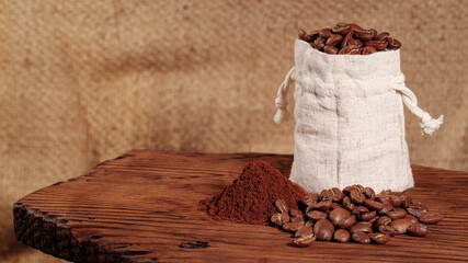 Arabica Coffee Beans Maragogipe in a Bag on a Wooden and Burlap Background. Elephant Beans with Ground Coffee