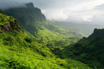 Fototapeta premium Verdant mountains cascade, shrouded in mist, unveiling a stunning vista of natural beauty