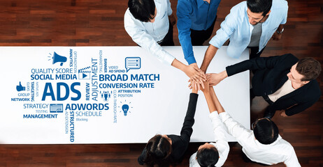 A dynamic business meeting showcasing a team collaborating on advertising strategies. The image...