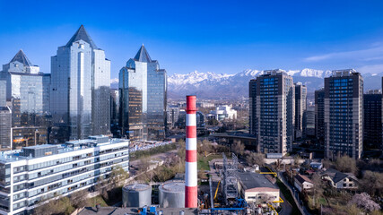 Naklejka premium Modern Business District with Skyscrapers and Mountain View