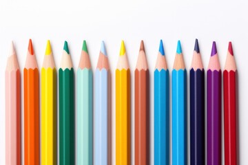collection of seven varicolored pencils arranged in a neat row displaying a spectrum of bright colors