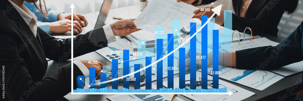 Poster a professional team engages in a detailed discussion of charts and graphs during a strategy meeting,