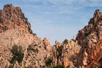 Fototapeta premium A picturesque view of rocky mountain formations under blue sky. Corsica