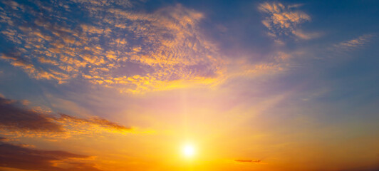 Fototapeta premium Beautiful sunset with bright sun and blue sky.