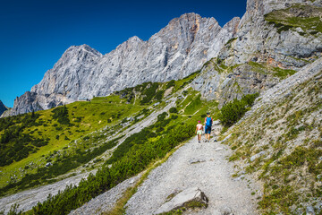 Hikers on the gravelly hiking trail, Dachstein mountains, Austria