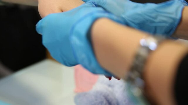 This clip shows a woman getting a paraffin wax treatment for her hands. Ideal for spa, beauty, and nail care content. Shows a warm, relaxing therapy.