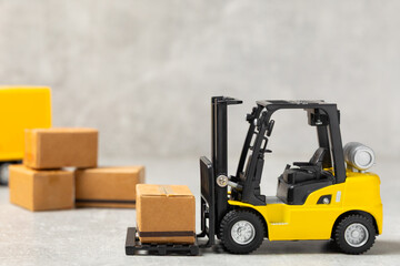 Yellow forklift on bright textured background. Logistics concept. Logistics and supply chain...