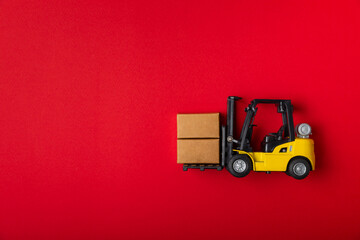 Yellow forklift on bright textured background. Logistics concept. Logistics and supply chain...