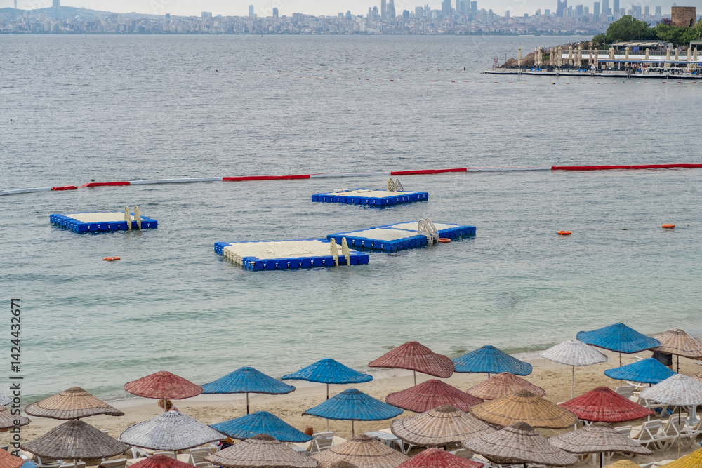 Poster visit to the beautiful prince islands beach with colorful umbrellas and floating platforms in the se