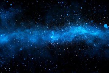 Naklejka premium Abstract blue glittering particles resembling a galaxy against a dark background