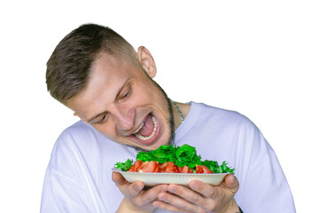 Bearded man in a white t-shirt joyfully pretending to eat a fresh vegetable salad with tomatoes and lettuce,  on a transparent background
