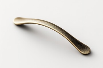 Elegant brass drawer handle resting on a smooth surface, showcasing its refined design and texture for a contemporary home aesthetic
