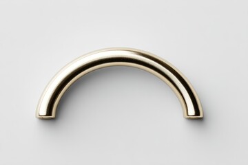 Golden curved handle on white background showcasing modern design and elegance for home decor