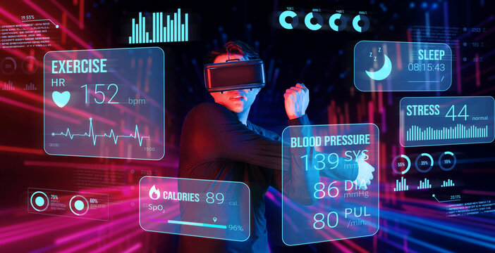 Asian man with VR glasses standing at abstract background while exercising and looking at hologram display data. Active male model using augmented reality technology. Technology innovation. Ingenuity.