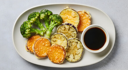 Delicious Tempura Platter with Assorted Vegetables and Savory Soy Sauce