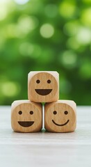 Three wooden block with happy face. Concept of satisfaction rating, customer happiness, emotion expression and positive feeling using wooden cube block on table.
