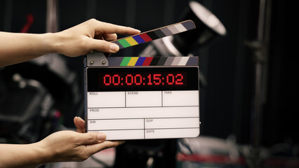 Digital film slate for filmmaker in set. Hand hitting timecode clapperboard or movie slate for...