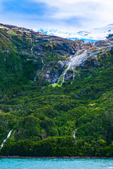 Fototapeta premium As glacial ice melts, the water flows downslope in the spring and summer forming beautiful waterfalls