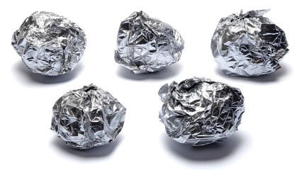 Five crumpled aluminum foil balls arranged artistically, highlighting texture and light reflections.