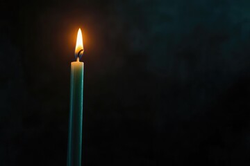 Fototapeta premium Solitary Candle Burning in the Dark - Symbol of Hope, Reflection, and Tranquility