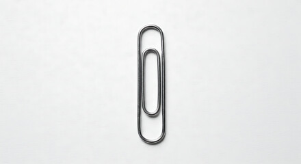 Single Black Paperclip on White Background