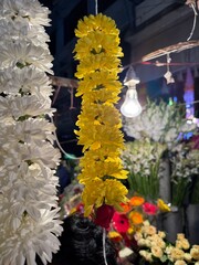 An autumnal bouquet of colorful chrysanthemums and roses with orange and yellow leaves on a fence