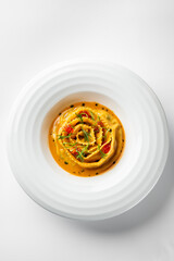 A beautifully plated pasta dish in a creamy tomato sauce, garnished with fresh herbs and cherry tomatoes. This elegant meal is perfect for Italian cuisine lovers.