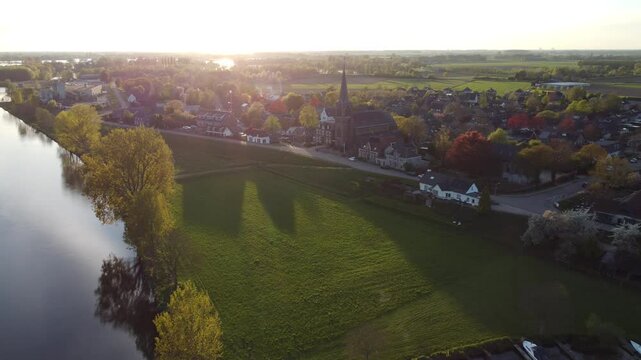 Appeltern, the Netherlands - April 19th 2025: Beautiful aerial footage of the village during the sunset. 