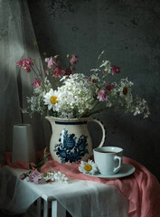 Delicate White Flowers Arranged in a Vintage Pitcher Sitting on a Charming Rustic Table