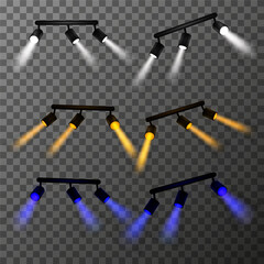 Set of lamps, spotlights of different colors: white, yellow and blue. Light rays have a realistic blurred effect. Composition of using track lights for accent lighting. Vector illustration EPS10.