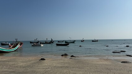 Expansive View of a Rugged Rocky Shoreline at Low Tide Meeting the Calm Blue Water and Clear...