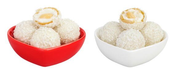 round candy raffaello with coconut flakes and nut in ceramic bowl isolated on white background