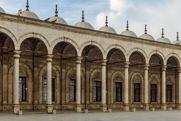 Capture the Mohammed Ali Mosque courtyard colonnade, showcasing alabaster art and Cairo Citadel view. Ideal for projects highlighting Islamic architecture and history.