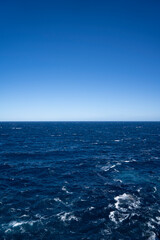view onto the mediterranean sea with georgous outlook on the rough blue sea and the blue sky in Mallorca Spain