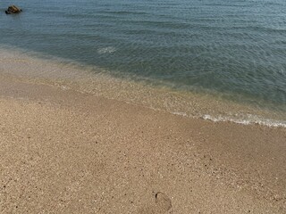 water, beach, sand, shoreline, ocean, sea, coast, nature, tranquil, peaceful, calm, serenity, clear water, wet sand, ripples, waves, gentle waves, shore, summer, travel, vacation, tropical, sunny, war