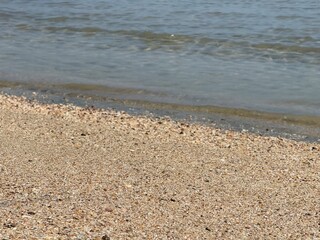 water, beach, sand, shoreline, ocean, sea, coast, nature, tranquil, peaceful, calm, serenity, clear water, wet sand, ripples, waves, gentle waves, shore, summer, travel, vacation, tropical, sunny, war
