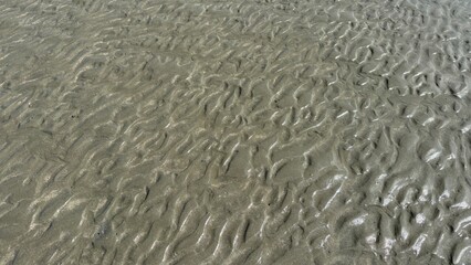 White sand beach texture with abstract blue water waves and natural surface reflection