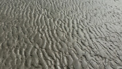 White sand beach texture with abstract blue water waves and natural surface reflection